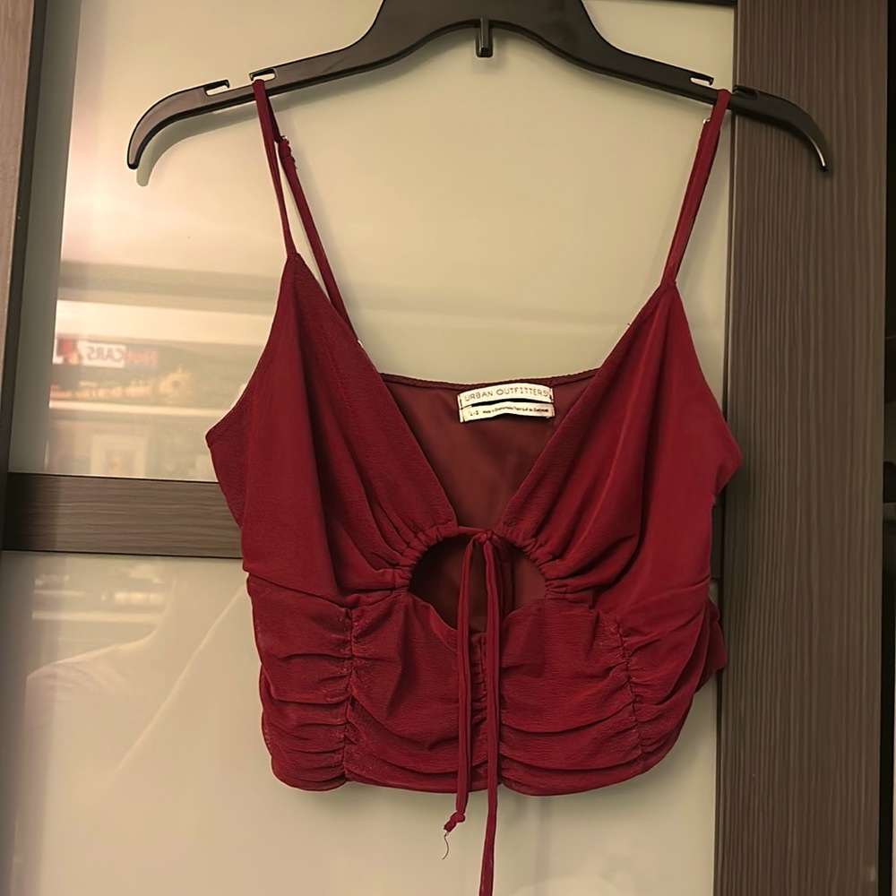 Cami from urban outfitters runs small fits like a medium and cropped